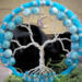 tree of life accents against a black background bringing out the beautiful sky blue colors